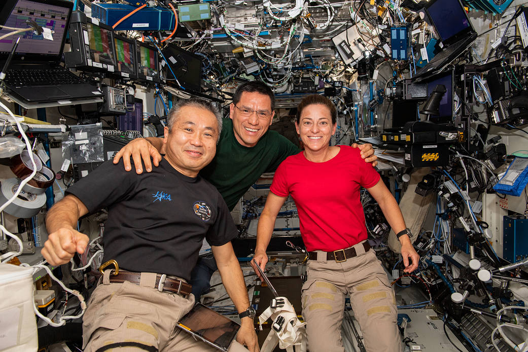 Three Expedition 68 Flight Engineers pose for a portrait