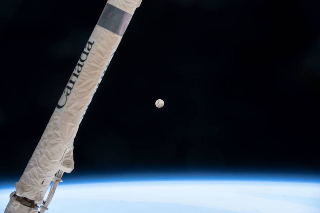 The waxing gibbous Moon above Earth’s horizon