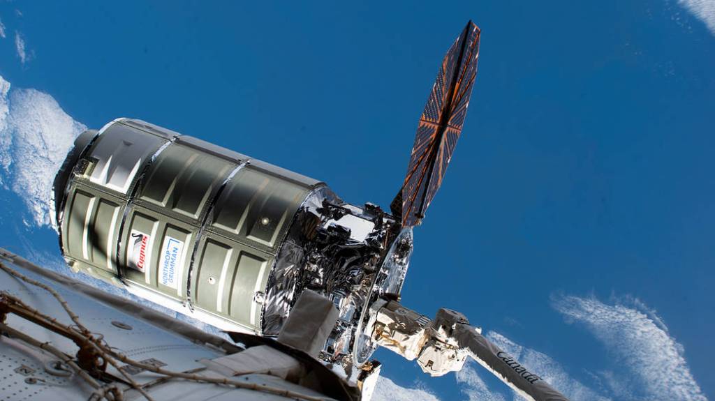 Cygnus is pictured in the grip of the Canadarm2 robotic arm