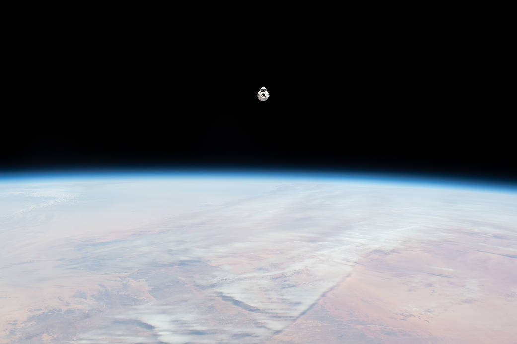 The SpaceX Dragon cargo craft approaches the space station