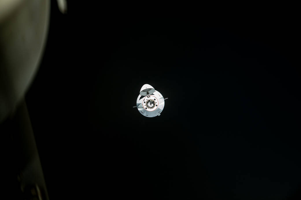 The SpaceX Dragon cargo craft approaches the space station