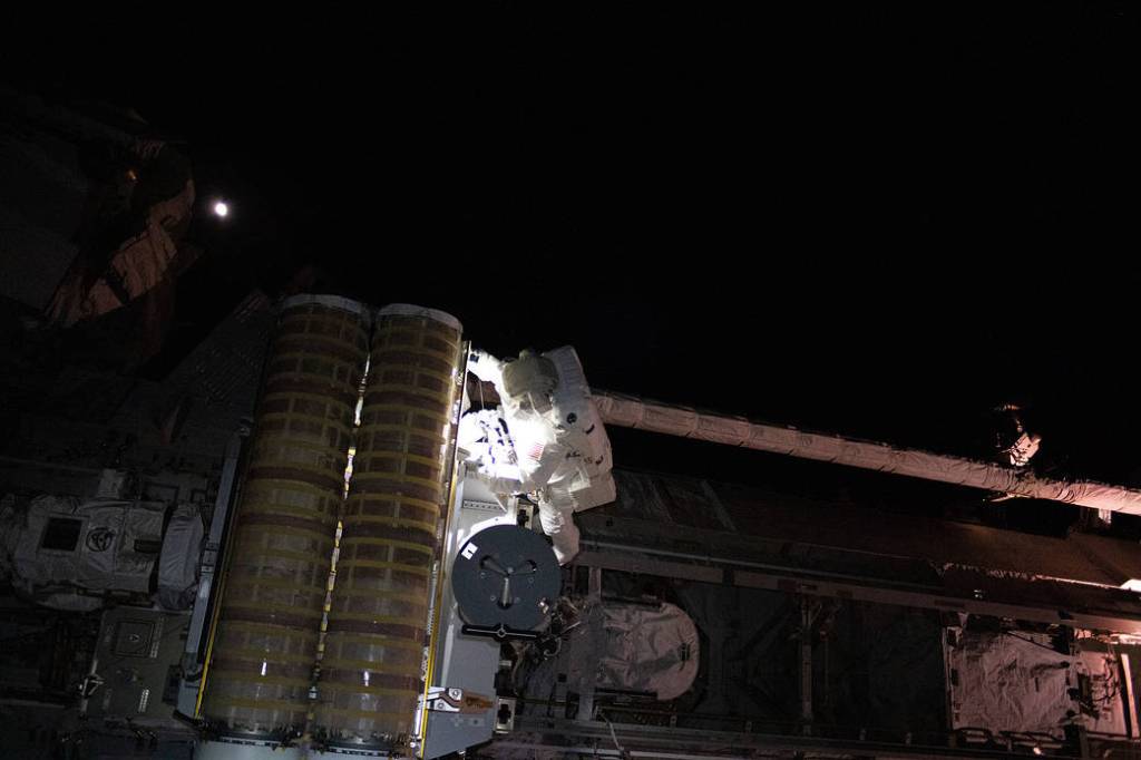 Astronaut Frank Rubio installs a roll-out solar array during a spacewalk