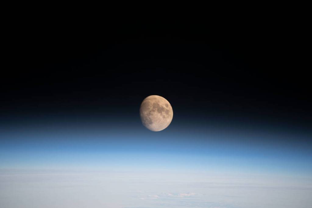 The waxing gibbous Moon above Earth’s horizon