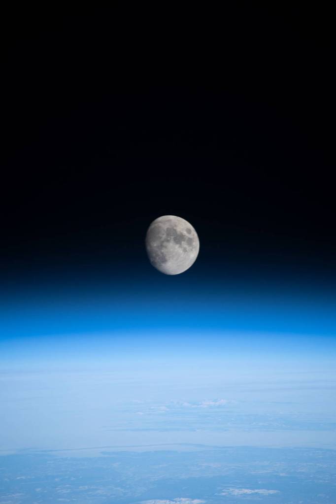 The waxing gibbous Moon above Earth’s horizon