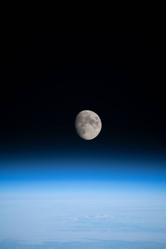 The waxing gibbous Moon above Earth’s horizon