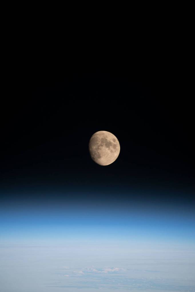 The waxing gibbous Moon above Earth’s horizon