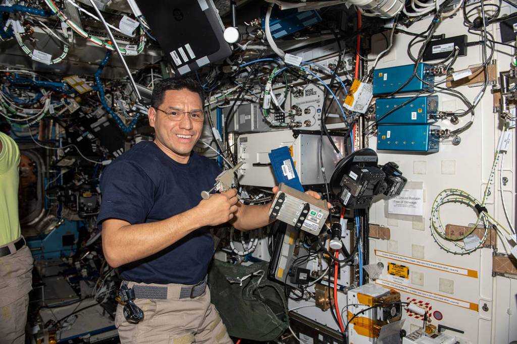 Astronaut Frank Rubio activates hardware for a space biology experiment