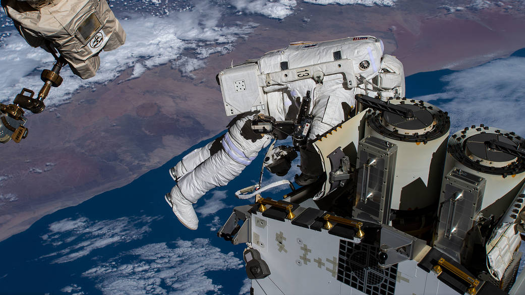 Spacewalker Josh Cassada prepares to deploy a roll-out solar array