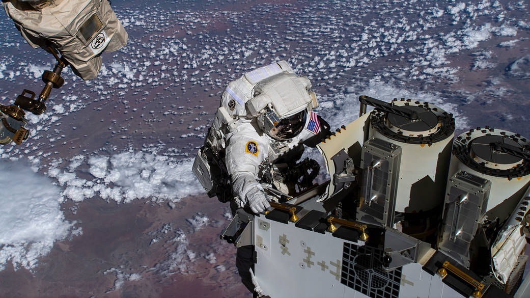 Spacewalker Josh Cassada prepares to deploy a roll-out solar array