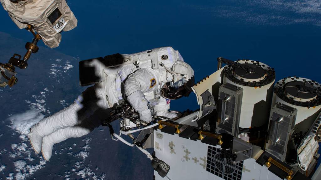 Spacewalker Josh Cassada prepares to deploy a roll-out solar array