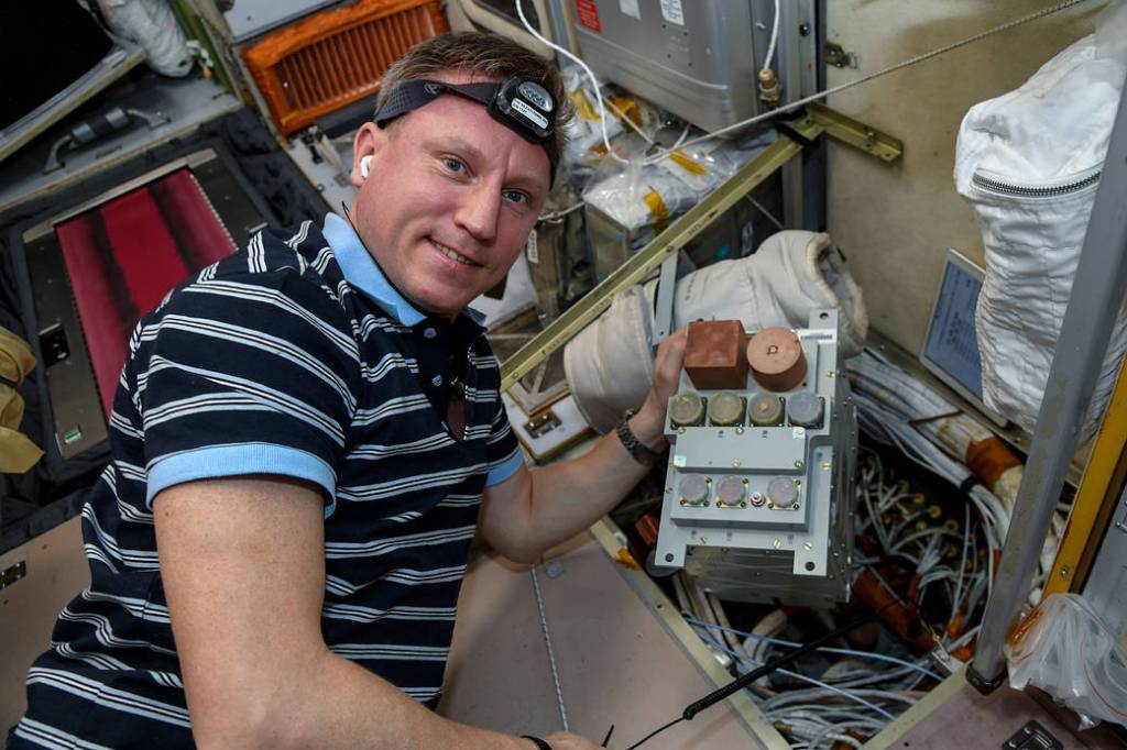 Commander Sergey Prokopyev works on space station maintenance