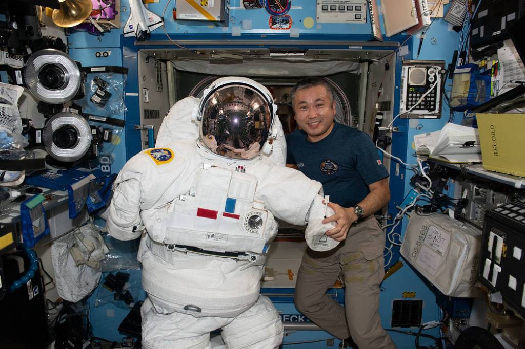 Astronaut Koichi Wakata poses with a spacesuit