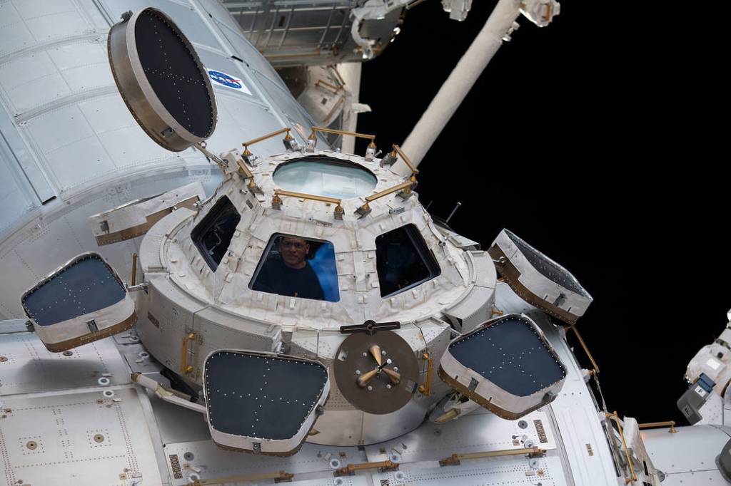 NASA astronaut Frank Rubio peers through a window in the cupola