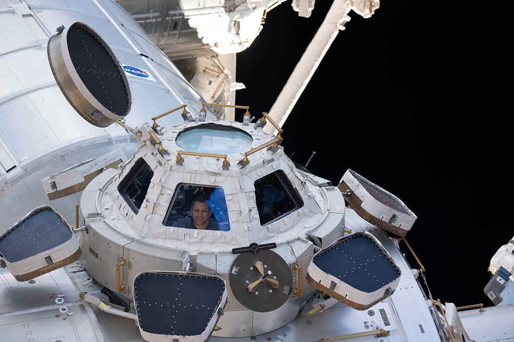 NASA astronaut and Expedition 68 Flight Engineer Josh Cassada peers through one of the seven windows in the cupola, the International Space Station's "window to the world."