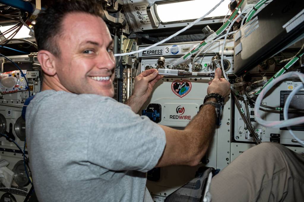 Astronaut Josh Cassada installs a biological 3-D printer