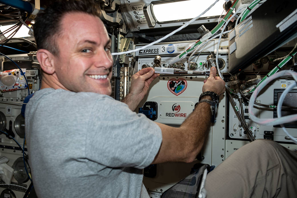 Astronaut Josh Cassada installs a biological 3-D printer