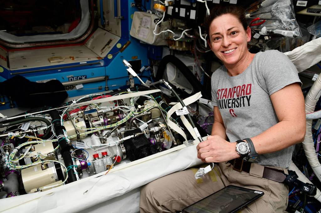 NASA astronaut Nicole Mann works on life support maintenance
