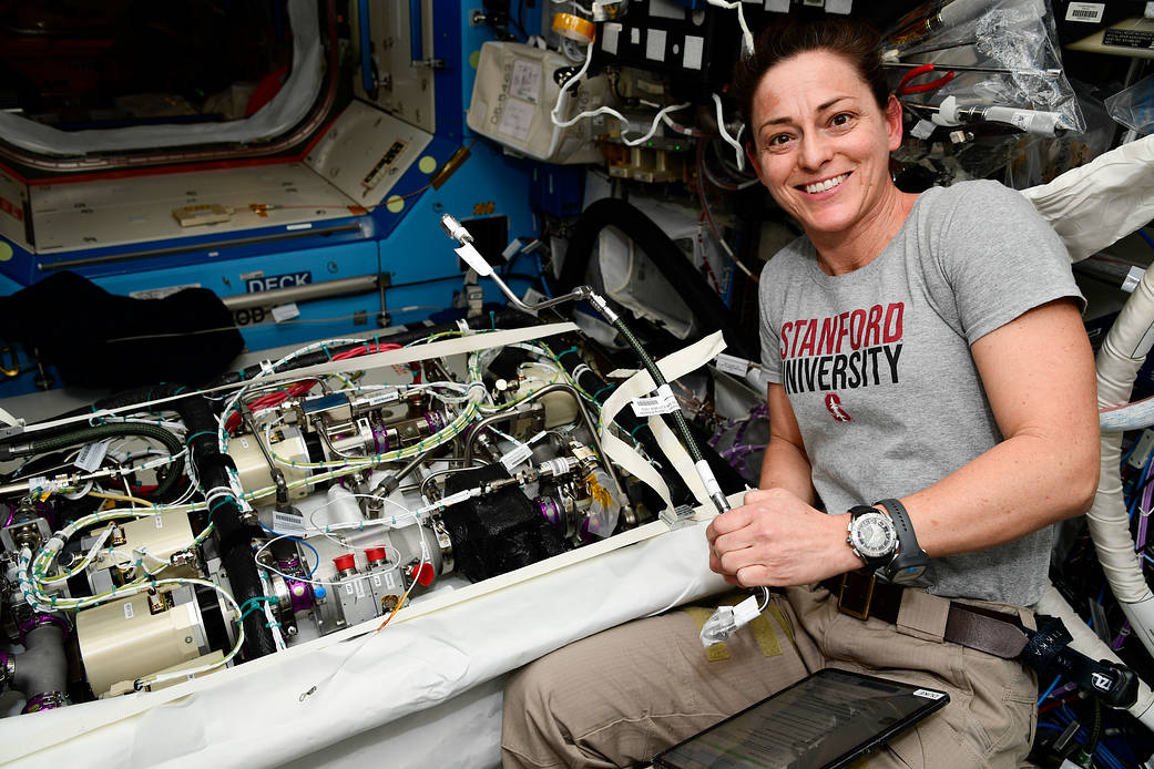 NASA astronaut Nicole Mann works on life support maintenance