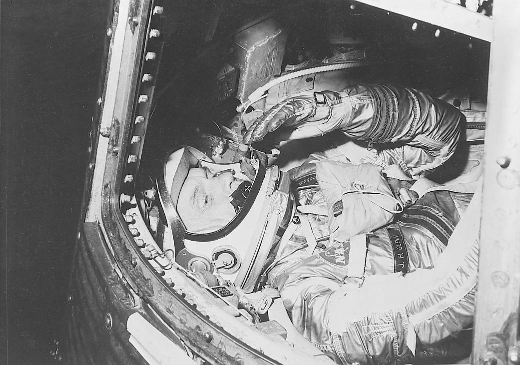 John Glenn in spacesuit inside Mercury capsule, close up