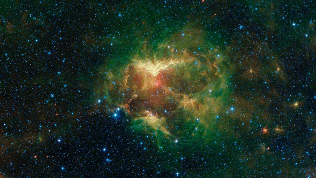 This carved-out cloud of gas and dust has been nicknamed the "Jack-o'-lantern Nebula" because it looks like a cosmic hollowed-out pumpkin.