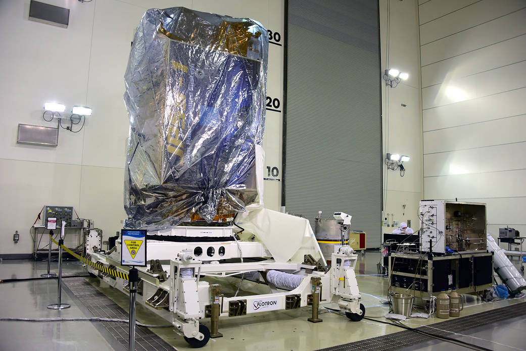 NOAA's JPSS-1 spacecraft remains wrapped in a protective covering after removal from its shipping container at Vandenberg