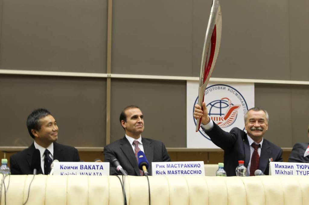 Soyuz Commander Mikhail Tyurin Hoists Model of Olympic Torch