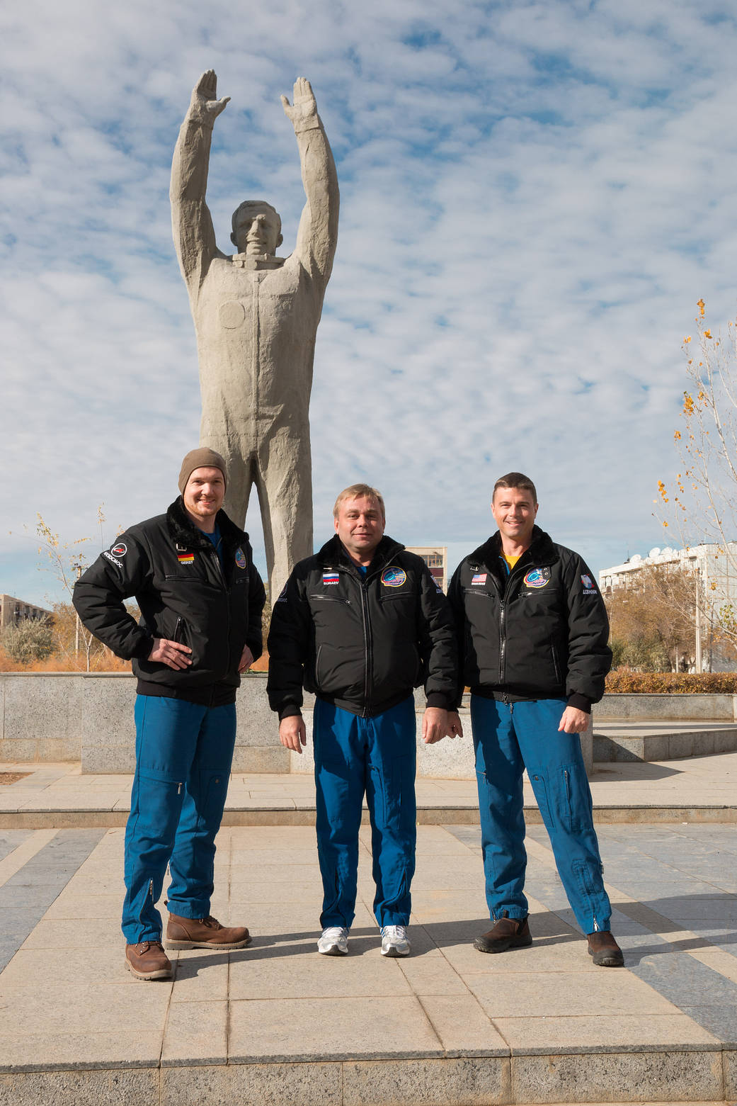 The Expedition 38/39 backup crew members stand in front of a statue of Yuri Gagarin