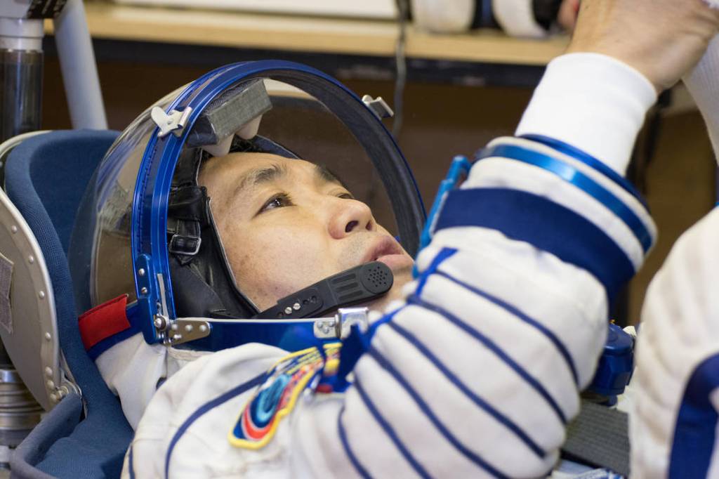 Koichi Wakata conducts a leak check of his Russian Sokol launch and entry suit