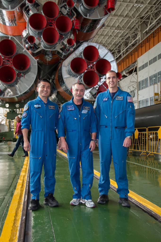 Koichi Wakata, Mikhail Tyurin and Rick Mastracchio in front of the first stage of their Soyuz rocket