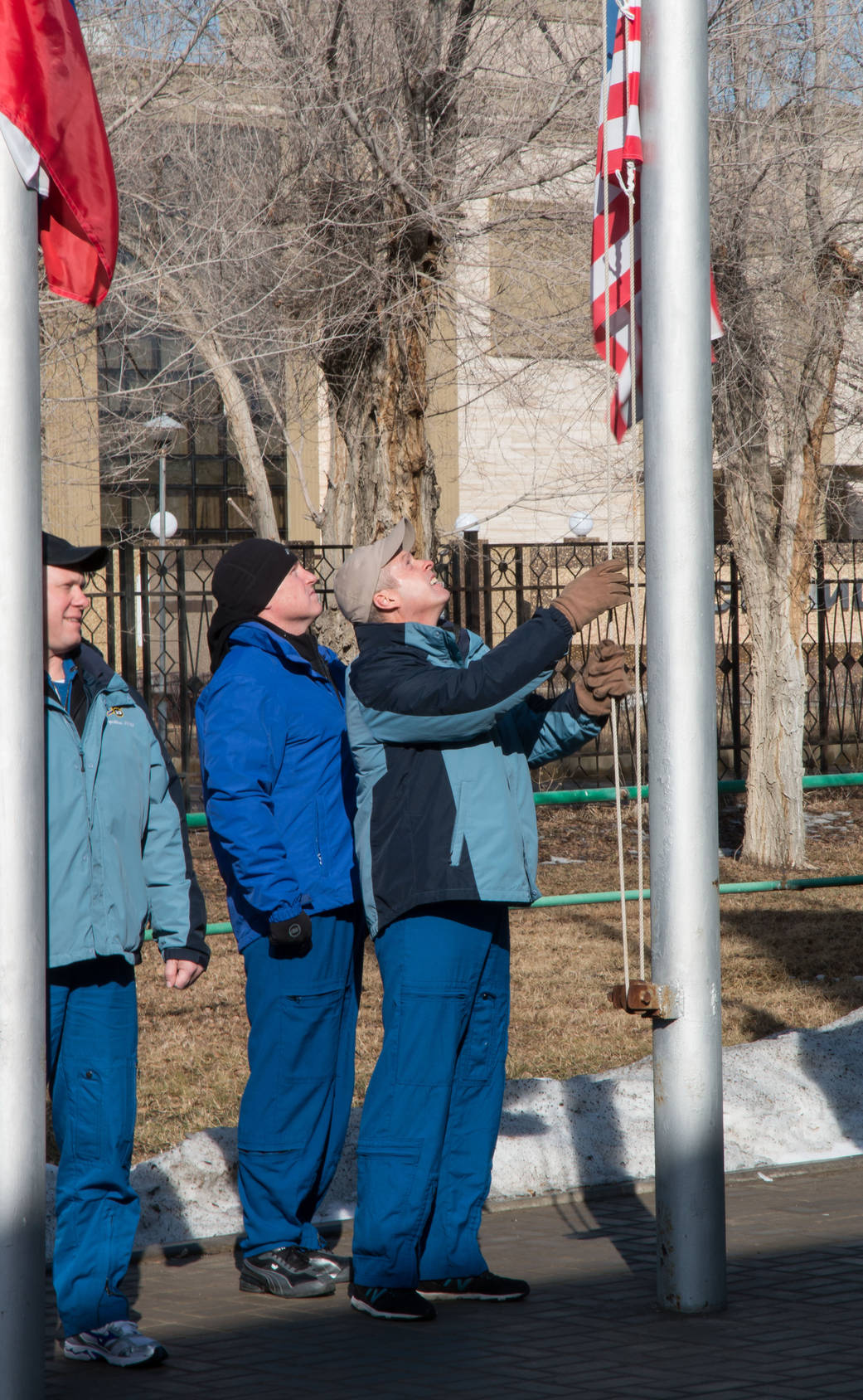 Steve Swanson and Barry Wilmore Raise the American flag