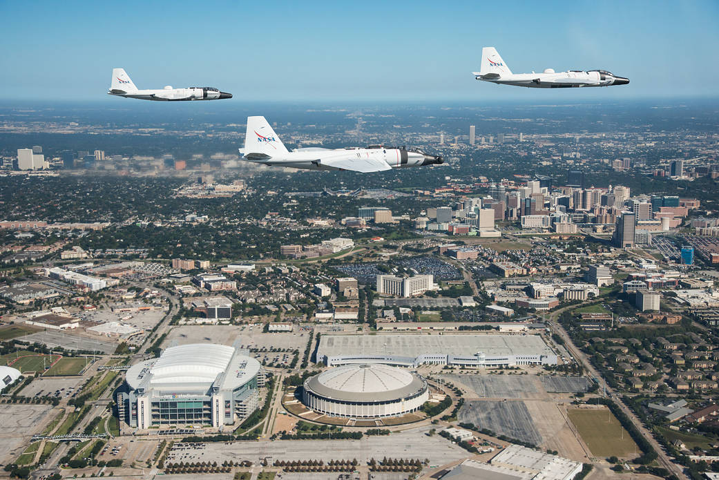  	 NASA's WB-57 aircraft flying in formation over Houston and JSC, photographed from a Navy T-6 aircraft