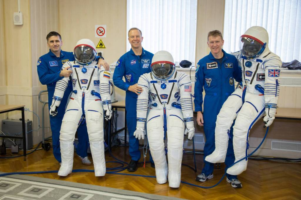 Expedition 46-47 Crew Members with their Sokol Launch and Entry Suits