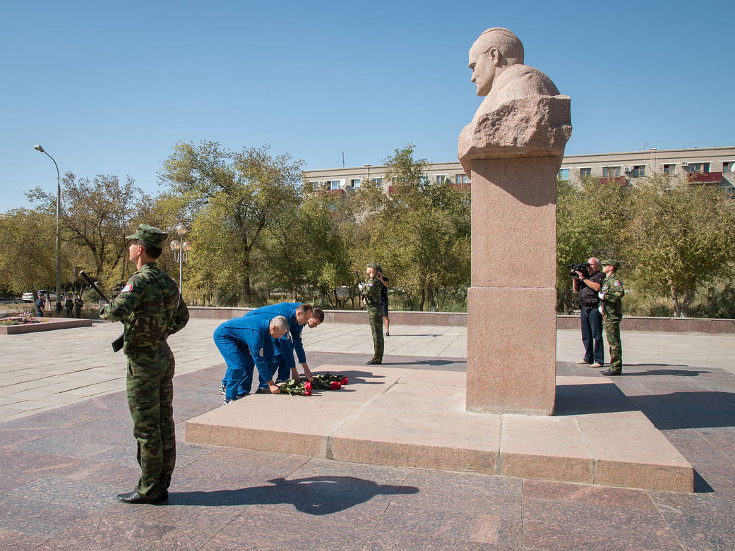 The Expedition 49 backup crewmembers lay flowers at the statue of Soviet rocket Great Designer Sergey Korolev