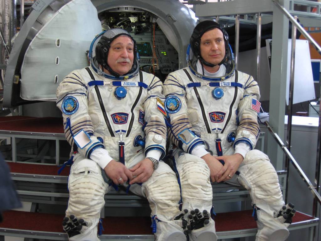 Fyodor Yurchikhin and Jack Fischer Pose in Front Soyuz Mockup