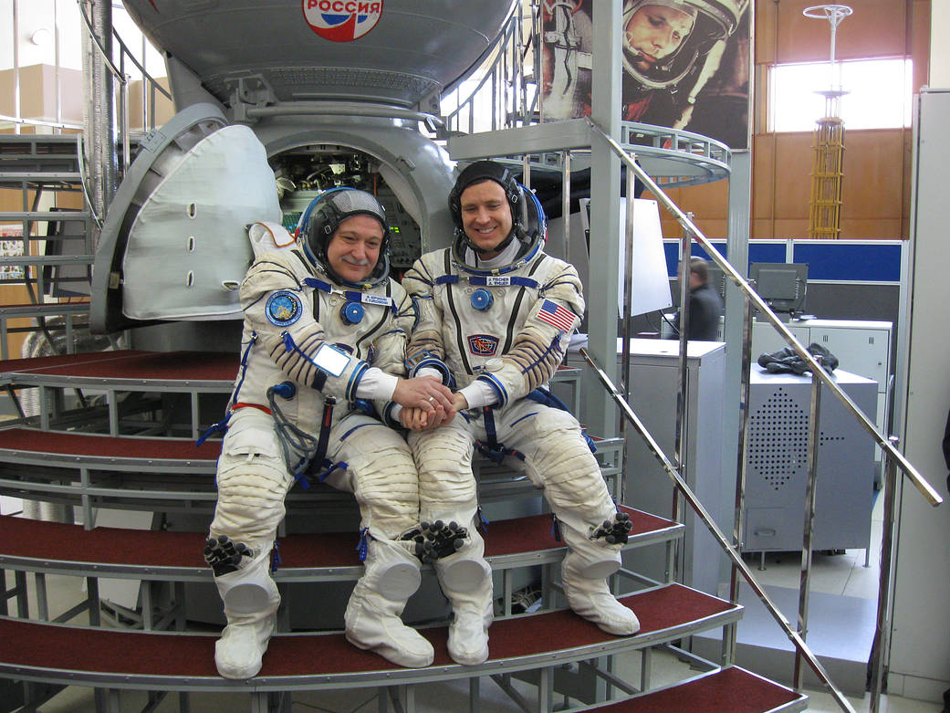 Fyodor Yurchikhin and Jack Fischer Pose in Front Soyuz Mockup