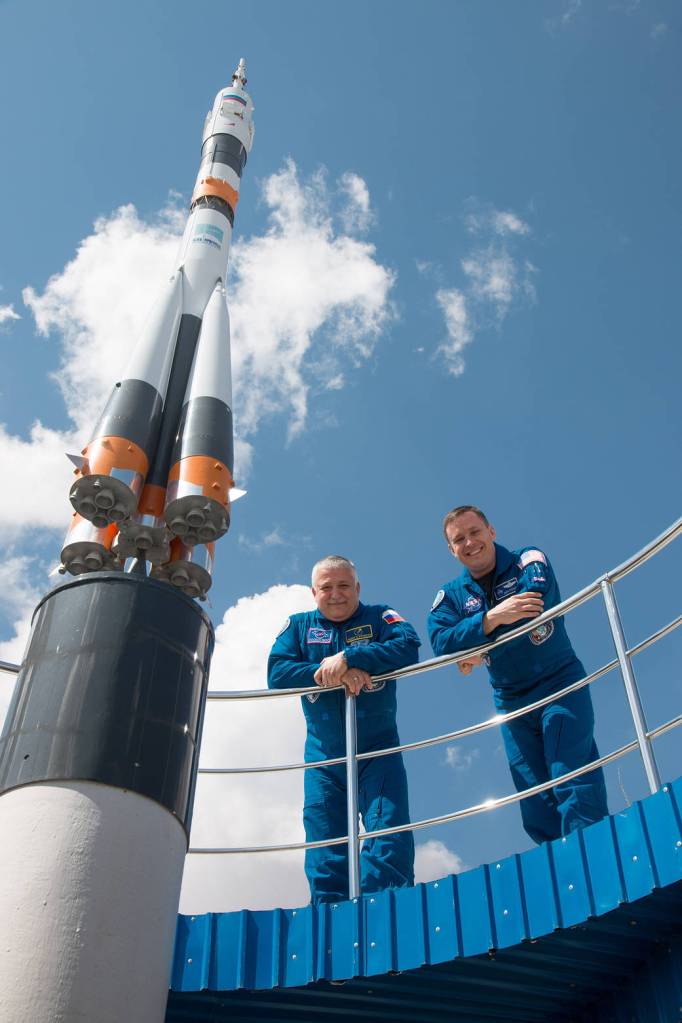 Expedition 51 Portrait Next to Soyuz Rocket Model