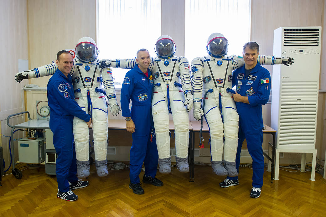 Expedition 52-53 crew with their Russian Sokol suits