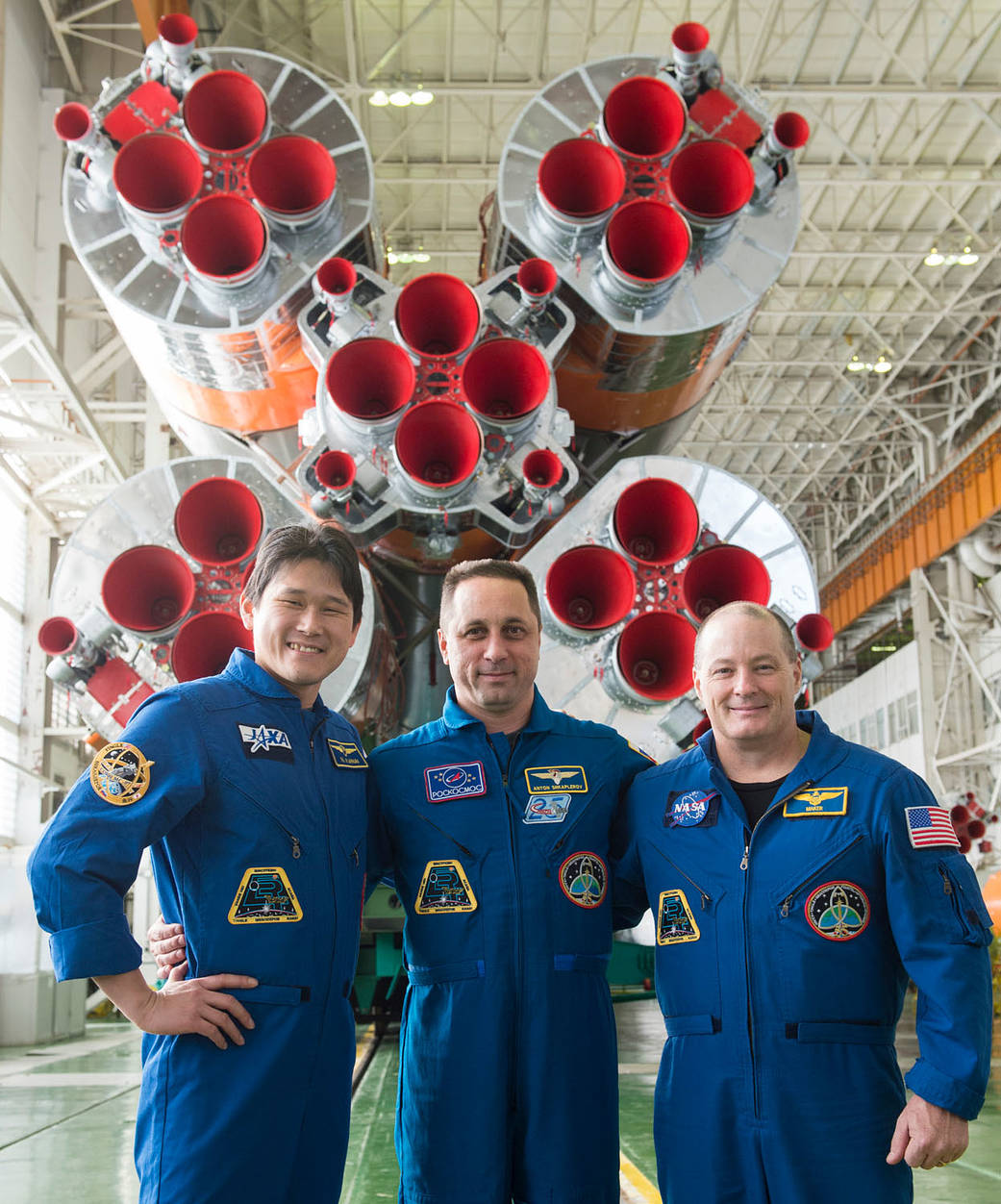 Expedition 54-55 Crew in Front of the Soyuz Boster Rocket