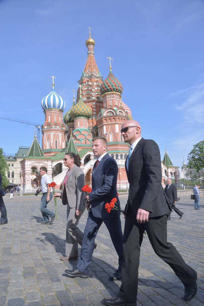 Expedition 56 crew members walk in front of St. Basil’s Cathedral at Red Square in Moscow