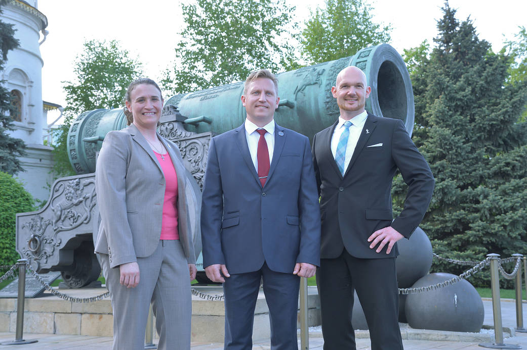 Expedition 56 crew members pose for pictures in front of the Tsar Cannon at the Kremlin