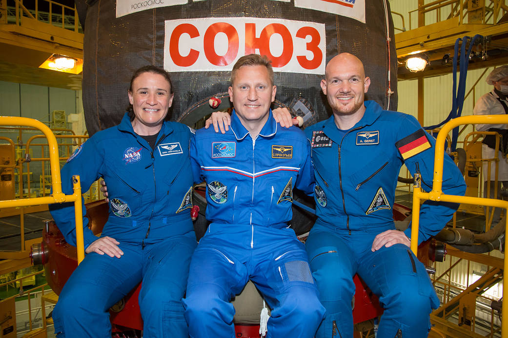 Expedition 56 crew members in front of the Soyuz MS-09 spacecraft