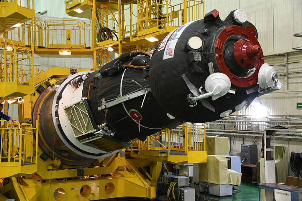 The Soyuz MS-09 spacecraft is lowered from its test stand
