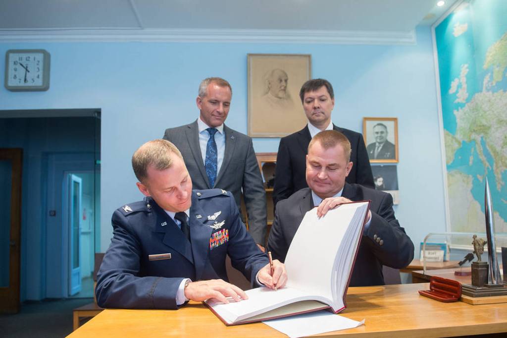 Expedition 57 crew member Nick Hague signs a ceremonial book