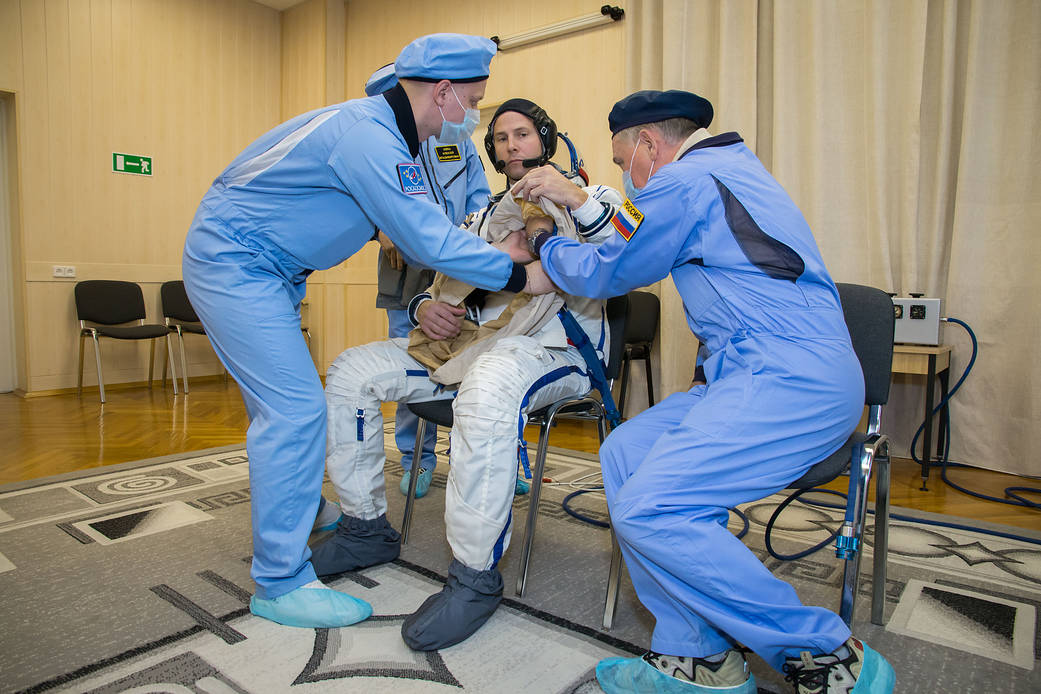 Expedition 57 crew member Nick Hague suits up in a Russian Sokol launch and entry suit