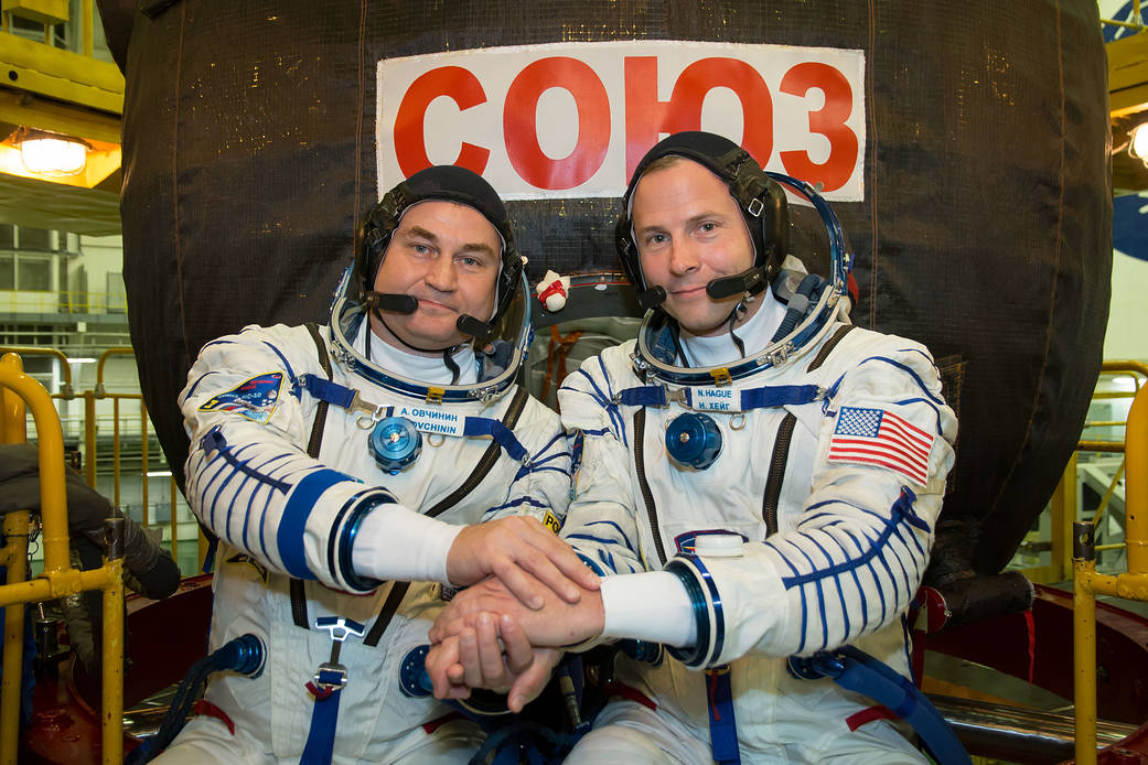 Expedition 57 crew members Alexey Ovchinin and Nick Hague pose in front of their Soyuz MS-10 spacecraft