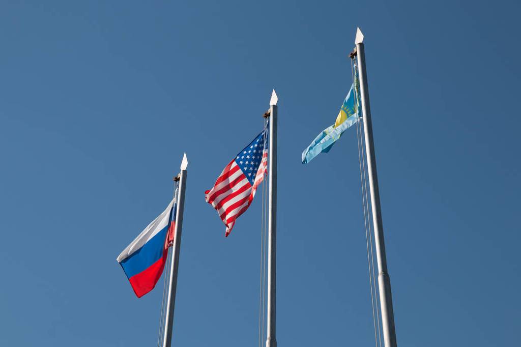 The flags of Russia, the United States and Kazakhstan fly high