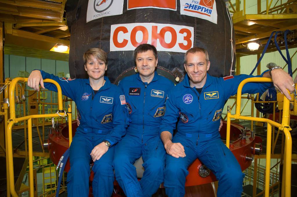 Expedition 58 crew members in front of their Soyuz MS-11 spacecraft