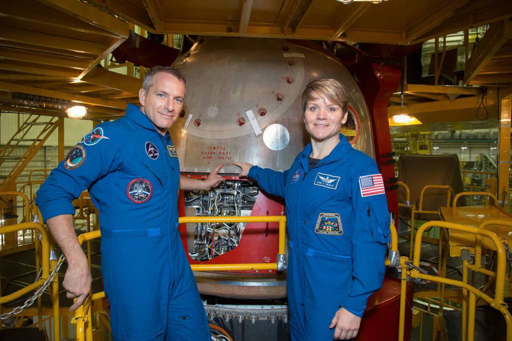 Astronauts David Saint-Jacques and Anne McClain pose in front of the Soyuz MS-11 spacecraft