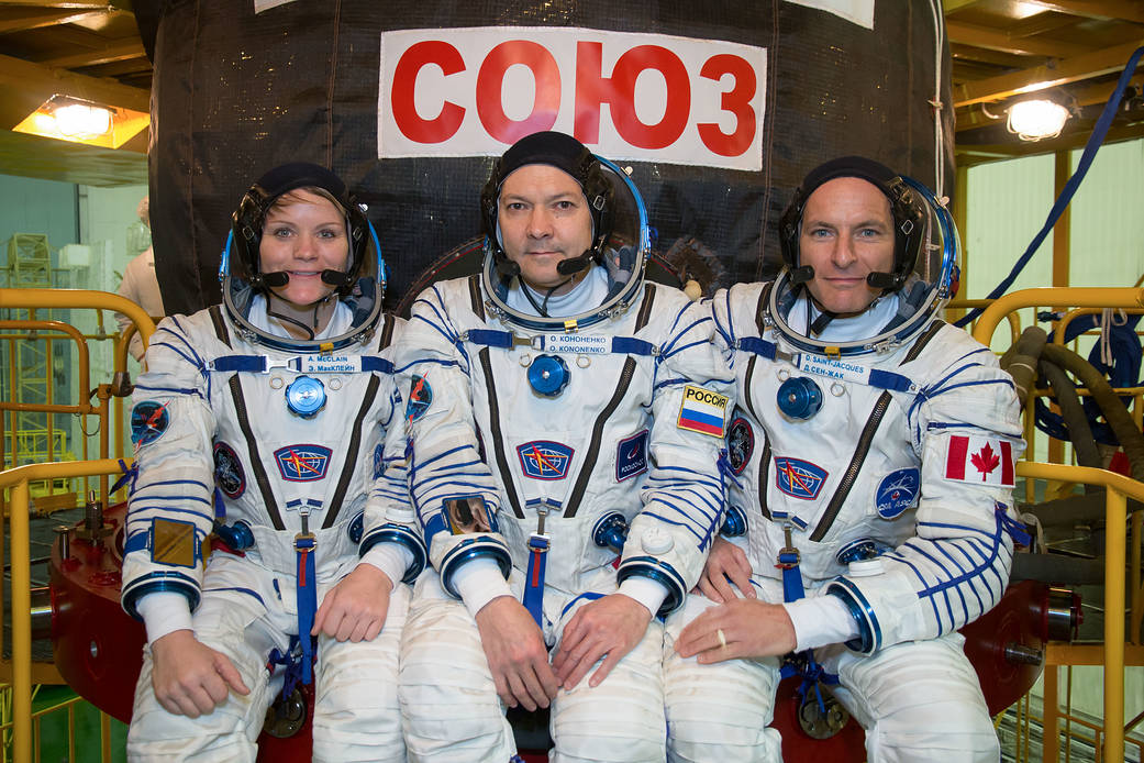 Expedition 58 crew in front of the Soyuz MS-11 spacecraft
