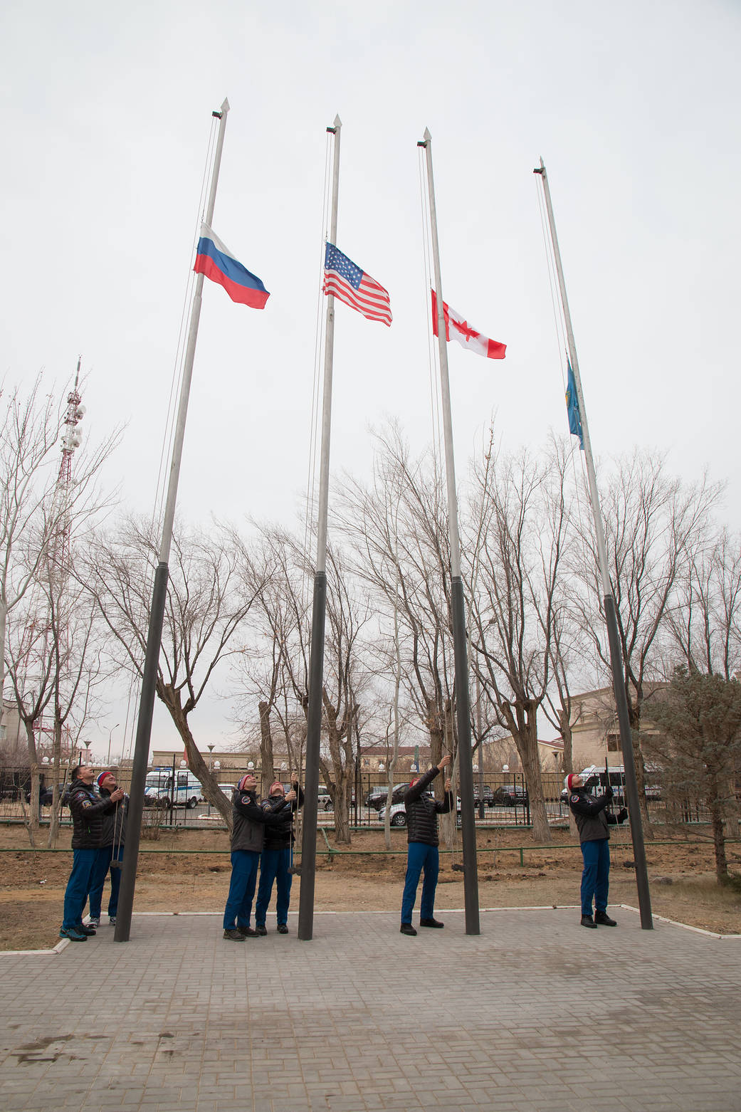 Expedition 58 prime and backup crew members raise the flags of Russia, the United States, Canada and Kazakhstan